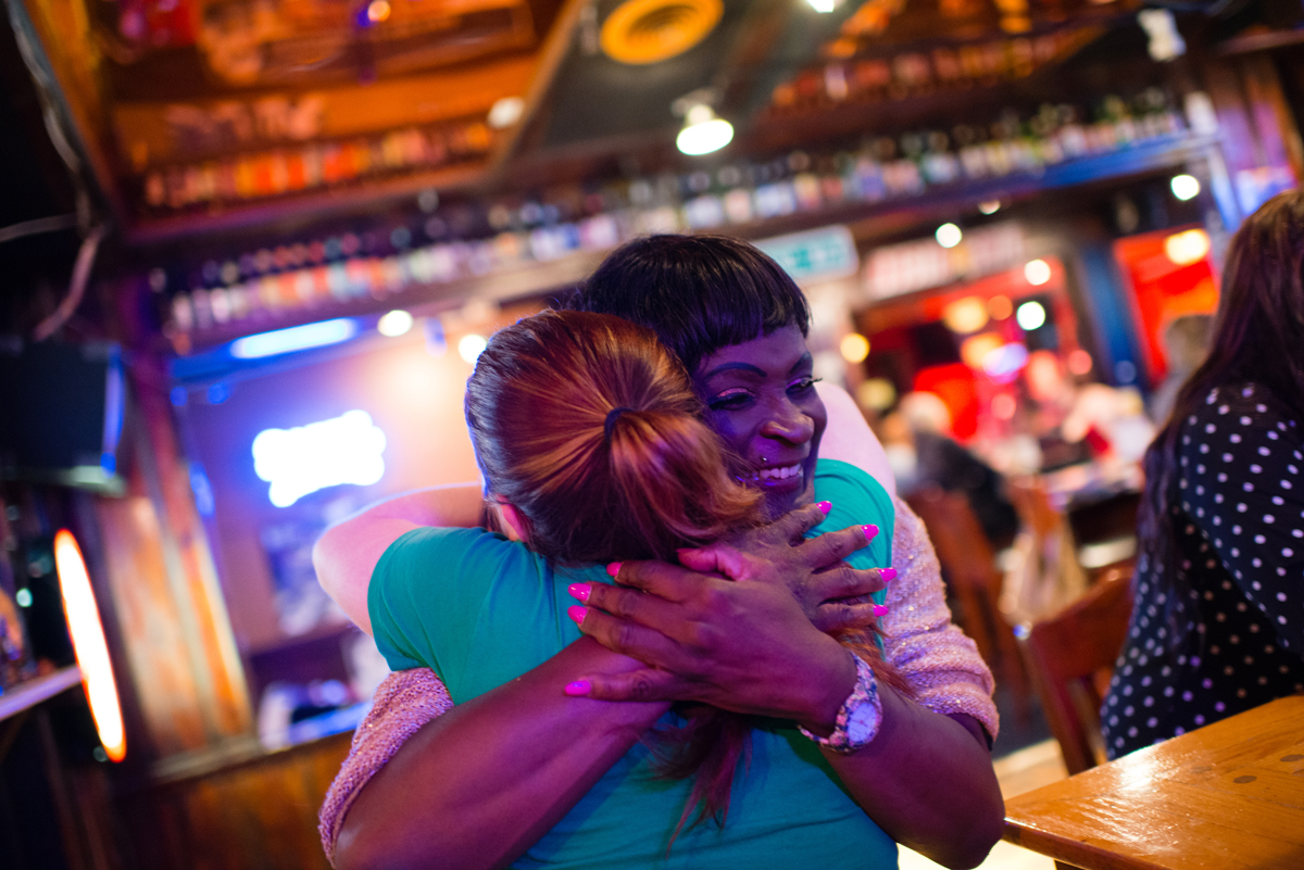 Sara Simone hugs a friend who provided shelter when she was homeless