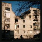 a building, damaged by bombing, shines in the light